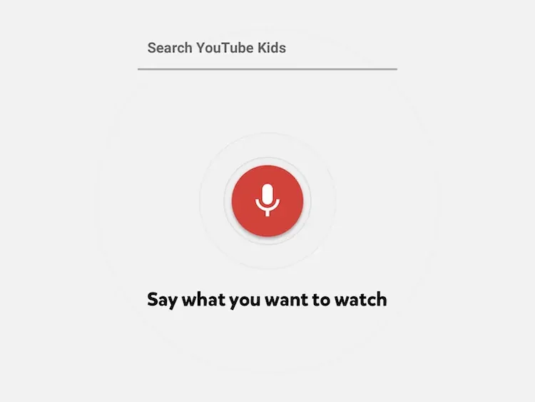 The MVP voice search screen: a red microphone button and the text Say what you want to watch